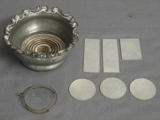 A circular planished pewter bottle coaster 4", a gilt monocle and 6 18th/19th Century carved mother of pearl game counters