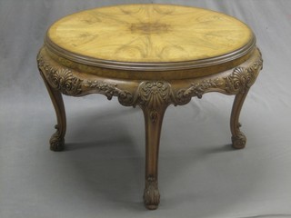 A circular carved walnut occasional table, raised on carved cabriole supports 30"