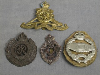 A Tank Corps cap badge, a Royal Artillery Officer's cap badge, a George VI Royal Engineers plastic cap badge and do. Reme