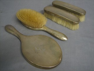 A silver backed 5 piece dressing table comprising hand mirror, hair brush, pair of clothes brushes