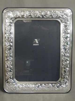 A modern embossed filled silver easel photograph frame 13" x 11"
