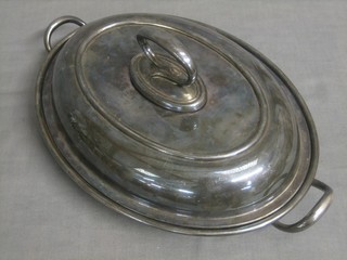 An oval silver plated twin handled entree dish and cover by Mappin & Webb