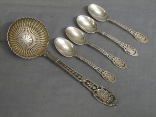 A Continental pierced white metal sifter spoon and 4 teaspoons