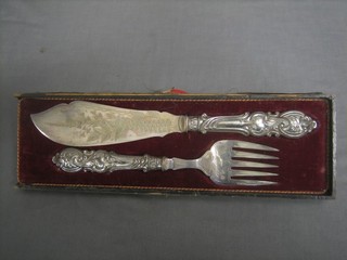 A pair of Victorian silver plated fish servers, cased