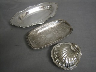 A silver plated scallop shaped butter dish and 2 rectangular silver plated dishes