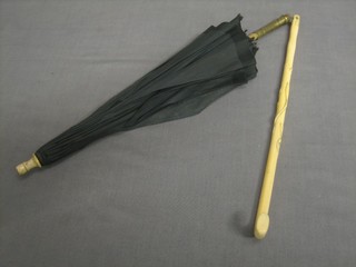 An Edwardian parasol with carved ivory handle