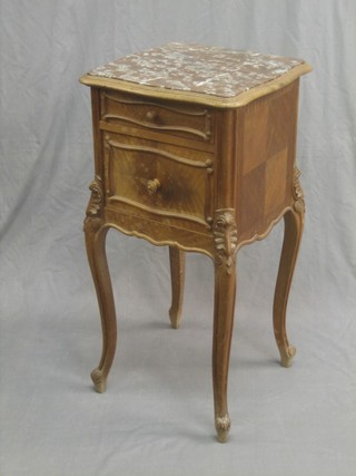 A French bleached walnut bedside cabinet of serpentine outline, the top with pink veined marble top, fitted a drawer and cupboard and raised on cabriole supports 15"