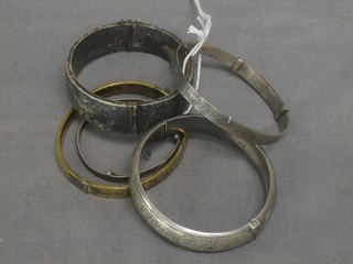 A gilt metal bracelet and 4 silver bracelets