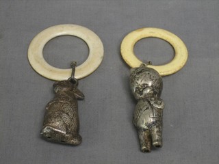 A childs silver plated rattle in the form of a rabbit and 1 other in the form of a standing child with teething rings