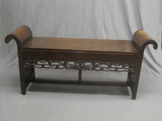A Chinese hardwood hall bench with hinged lid, blind fret work decoration and scrolled shaped arms 57"