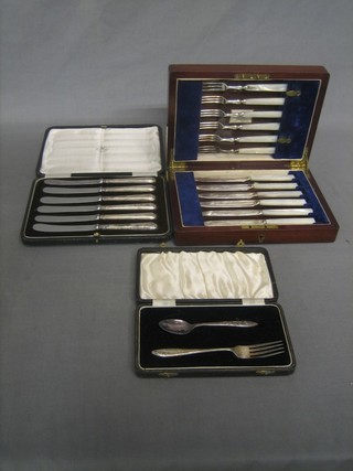 A silver plated 2 piece christening set, a set of 6 silver plated tea knives and a set of 6 silver plated fruit knives with mother of pearl handles, all cased