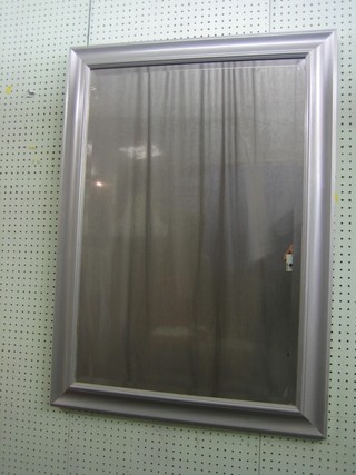 A rectangular bevelled plate mirror contained in a silver frame 30"