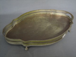 An oval shaped and silver plated galleried tea tray, raised on 4 paw feet 24"