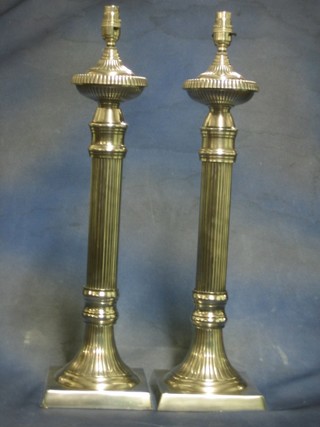 A large and impressive pair of silver plated table lamps with reeded  columns 24"