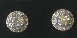 A pair of impressive circular old cut diamond ear studs with central diamond surrounded by diamonds approx 0.25/1.45ct