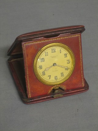An 8 day clock travelling by Tiffany & Co contained in a leather case