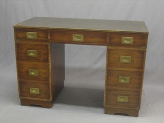 A mahogany military style kneehole pedestal desk with inset tooled leather writing surface above 1 long and 6 short drawers, raised on bracket feet 45"