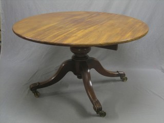 A circular William IV Mahogany snap top breakfast table, raised on pillar and tripod supports 50"