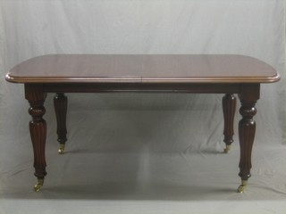 A Victorian style mahogany extending dining table, raised on turned and reeded supports  68" with 2 extra leaves extending to 108"