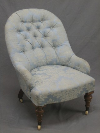 A Victorian oak framed nursing chair upholstered in blue material