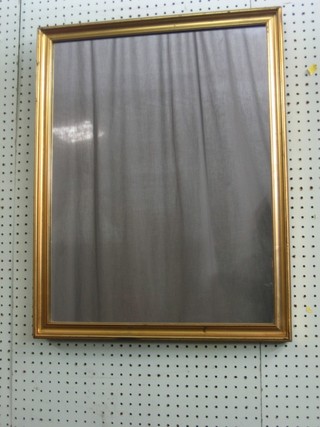 A rectangular plate wall mirror contained in a decorative gilt frame 26"