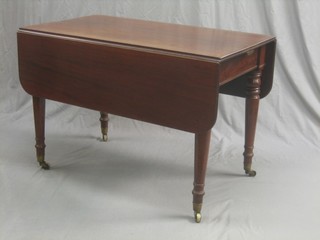 A Victorian mahogany drop flap dining table with 1 extra leaf, raised on turned supports 42"