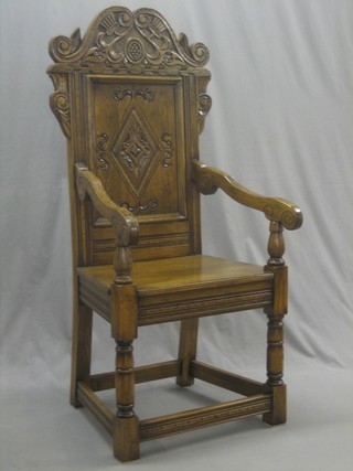 A carved oak Wainscot chair, heavily carved throughout and raised on turned and block supports