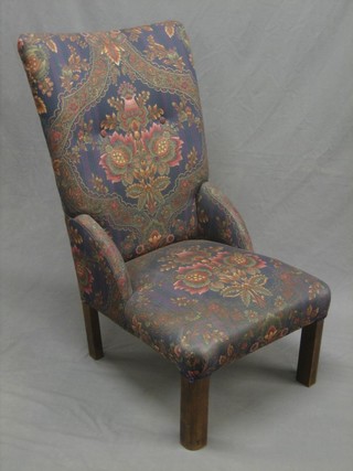 A beech framed nursing chair upholstered in floral material