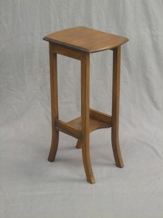 An Edwardian Art Nouveau mahogany 2 tier occasional table raised on square supports 9"