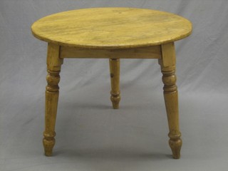 A 19th Century circular pine cricket table, raised on turned supports 31"