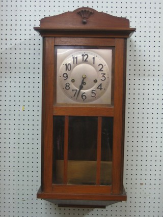 A Gecco chiming wall clock with 8" square silvered dial and Arabic numerals contained in an oak case
