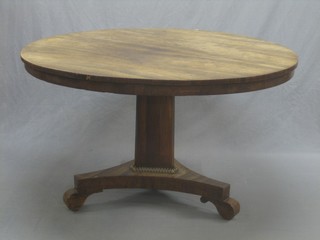 A circular William IV rosewood snap top breakfast table, raised on a chamfered column with triform base 48"
