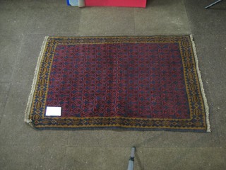 A contemporary red ground Persian Belouch rug 48" x 32"