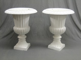 A handsome pair of Victorian style trumpet shaped cast iron urns with egg and dart borders, raised on square bases with associated wooden bases 22"