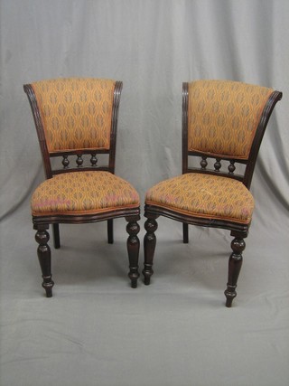 A set of 10 Victorian style mahogany show frame dining chairs with upholstered seats and backs, raised on turned supports