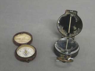 A compass marked HAP 15 58530 together with a small 19th Century brass pocket compass (2)