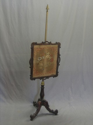 A William IV mahogany pole screen with rectangular floral Berlin wool work column, with brass column raised on a turned and reeded pillar and tripod support