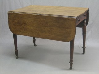 A 19th Century mahogany Pembroke table fitted a frieze drawer and raised on turned supports 39"