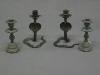 A pair of Benares brass candlesticks in the form of Cobras 6" and 1 other pair of candlesticks