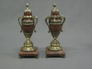 A pair of 20th Century polished granite twin handled urns and covers 12"