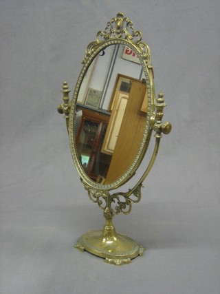 An oval plate dressing table mirror contained in a decorative gilt frame 19"