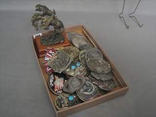 A bronzed figure of Frederick Remmington and 19 various American belt buckles
