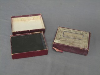 2 boxes containing glass photograph plates