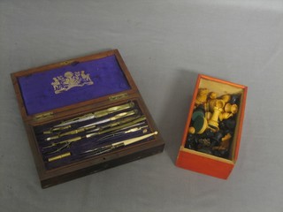 A chess set and a geometry set contained in a rosewood case