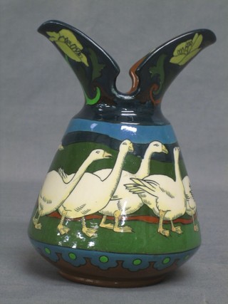 An Art Nouveau pottery double spouted jug/vase, the body decorated running geese, the base marked 7007 "Intarsio" RD330400 6"