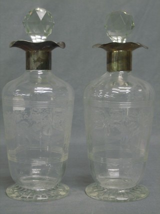 A pair of etched glass decanters and stoppers with silver collars (stoppers chipped and 1 interior cracked) 11"