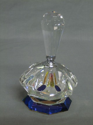 A circular glass scent bottle and clear glass stopper, raised on an octagonal base 7" 