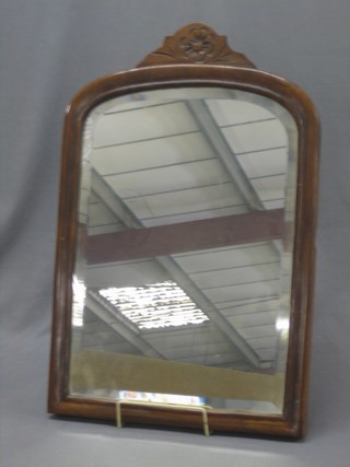 A 19th Century arched plate mirror contained in a walnut frame 16"