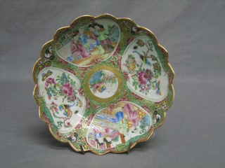 A circular Canton famille rose porcelain bowl with scallop edge and panel decoration depicting court figures 10"