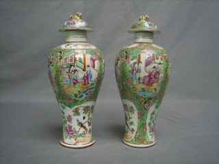 A pair of 19th Century Canton club shaped vases and covers decorated court scenes (1 chipped to lid and crack to rim) 12"